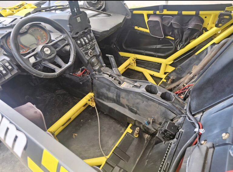 Side-by-side chassis lifted for electrical and drivetrain inspection during Powersports diagnostics